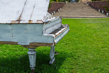 abandoned old piano left outside in the yard