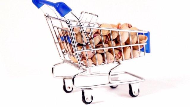 Small shopping cart with pistachios circling isolated