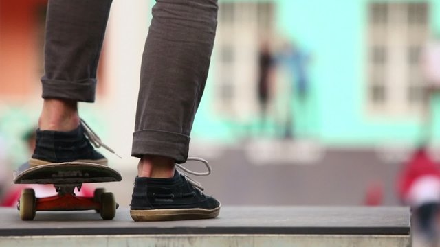 Legs of skateboarder which star ride on board from ramp