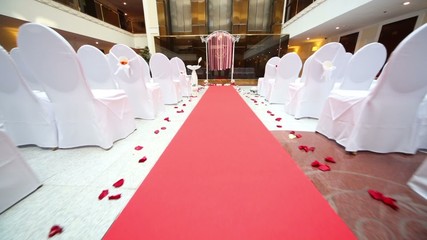 Moving along chairs at hall for a wedding ceremony 