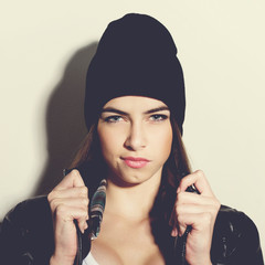 Hipster teenage girl with black beanie hat posing