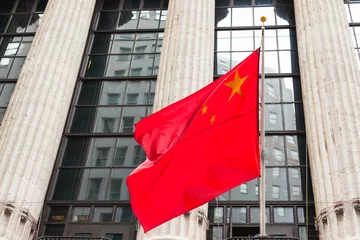  Chinese flag floating in front of a goverment building © Samuel B.