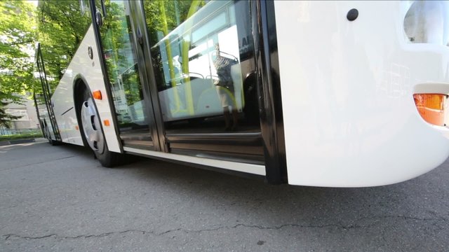 Modern bus open and close doors with woman reflection on glass