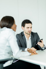 Businessman looking at his phone in an office