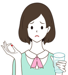 女性　薬　カプセル　困り顔