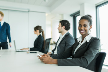 Young business people sitting at a conference table