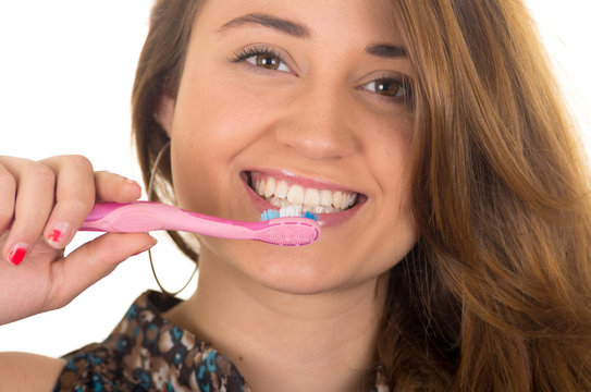 beautiful young smiling woman brushing teeth