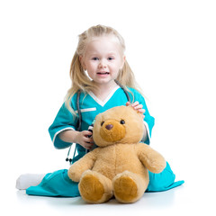 kid girl playing doctor with plush toy