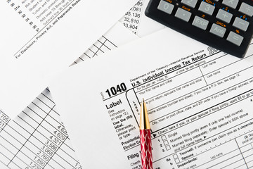 income tax return with pen and calculator