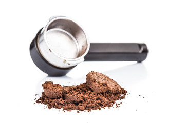 Spentcoffee grounds with portafilter at the background