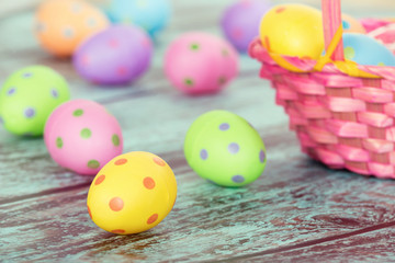 Pastel Easter eggs on vintage green wooden background