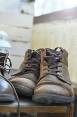 Vintage brown shoes on the old shelf at the balcony