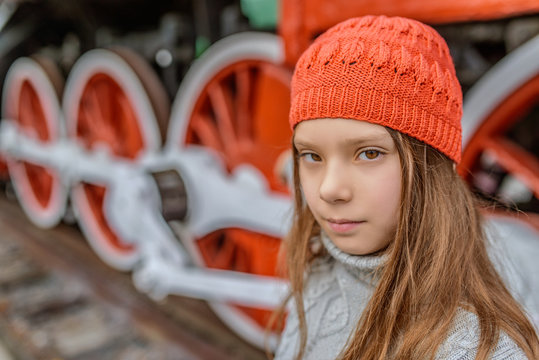 little girl near the old steam locomotive