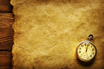 Pocket clock on old paper