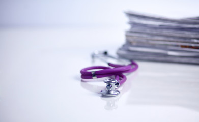 Medical stethoscope on the stack of paper