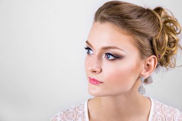 woman with makeup. hair style. large ring and earrings