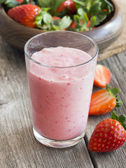 Strawberry smoothie on rustic background