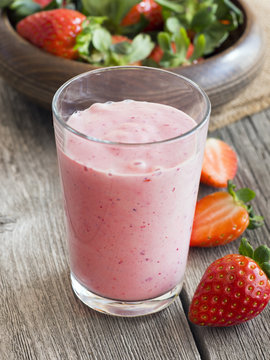 Strawberry smoothie on rustic background
