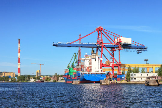 Large container ship in a dock at port of Gdansk, Poland.
