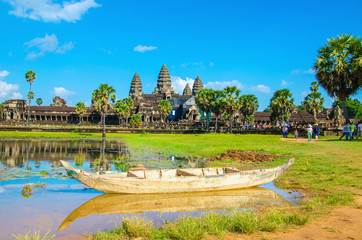 Angkor Wat with old boat seen across the lake, Cambodia