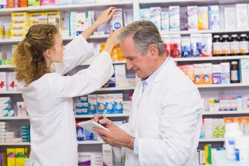 Fototapeta na wymiar Pharmacists searching medicines with prescription
