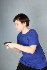 Boy with a joystick playing computer game