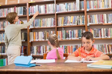 Teacher looking for a book at library