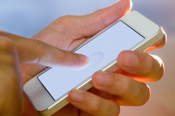 Hand holding a white smartphone