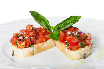 Bruschetta with red tomatoes and green basil