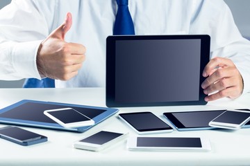 Businessman with smartphones and tablet