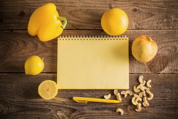 Yellow fruits and vegetables on wooden background