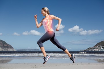 Highlighted back bones of jogging woman on beach