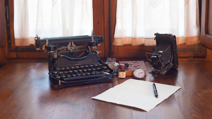 Vintage items, camera, pen, globe, clock, typewriter on the old
