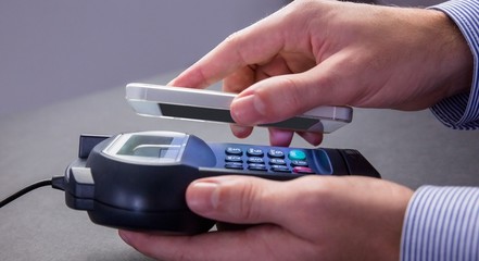 Man using smartphone to express pay