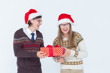 Geeky hipster couple holding present