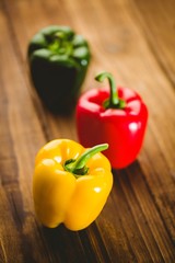 Three peppers on chopping board