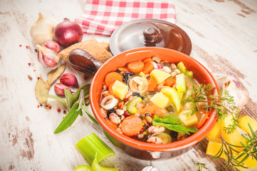 Rural vegetarian broth soup with colorful vegetables and rustic