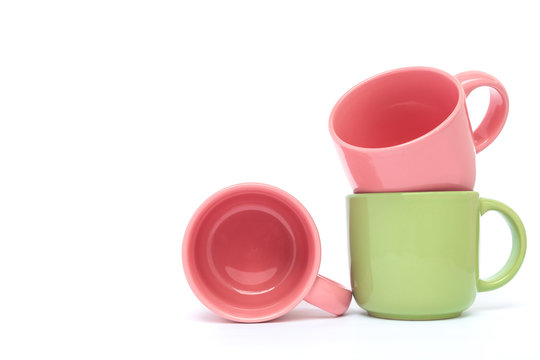 Pink and green ceramic coffee cup on white background