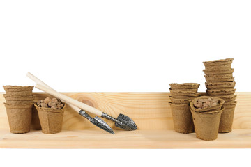 Little garden shovels alongside peat pots