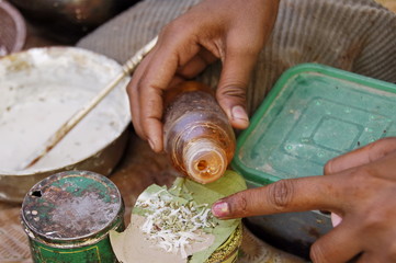 Preparing "paan" - betel leaf with areca or tobacco, India.