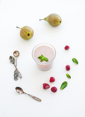 Glass of raspberry and pear smoothie with fresh mint leaves