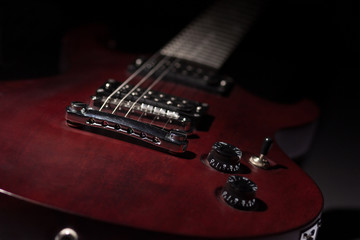 Red electric guitar on a black background