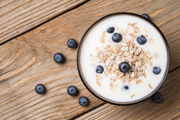 Muesli with yoghurt and ripe berries blueberry. View from the to