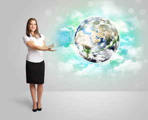 Fototapeta premium Young woman with earth and cloud concept
