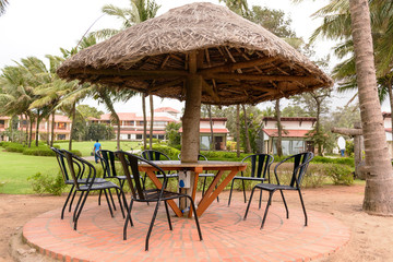 Tropical restaurant with straw sunshade umbrella