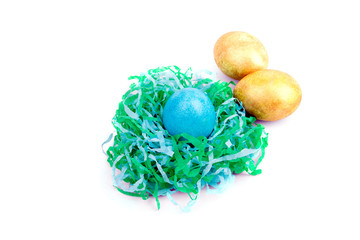 multicolored Easter eggs in paper nest