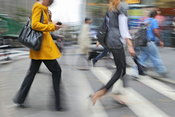 motion blurred business people walking on the street