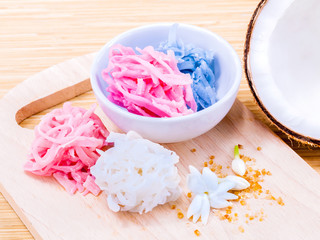 A colorful traditional coconut dessert made from grated coconut