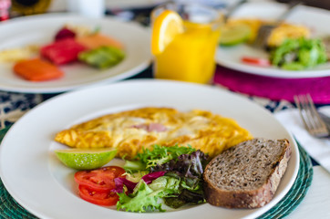 Delicious mexican style breakfast with omlette, ham and bread