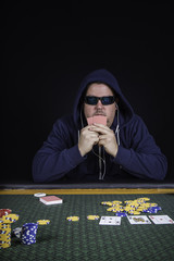 A man playing poker sitting at a table